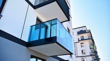 Exterior of a modern multi-story apartment building - facade, windows and balconies. photo