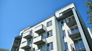 Exterior of a modern multi-story apartment building - facade, windows and balconies. photo