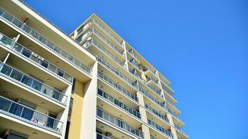 Exterior of a modern multi-story apartment building - facade, windows and balconies. photo