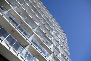 Exterior of a modern multi-story apartment building - facade, windows and balconies. photo