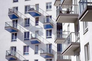 Exterior of a modern multi-story apartment building - facade, windows and balconies. photo