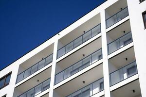 Exterior of a modern multi-story apartment building - facade, windows and balconies. photo