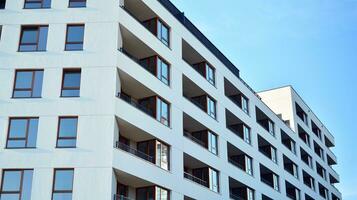 Exterior of a modern multi-story apartment building - facade, windows and balconies. photo