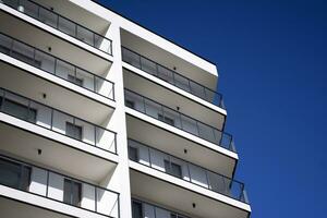 Exterior of a modern multi-story apartment building - facade, windows and balconies. photo