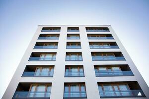 Exterior of a modern multi-story apartment building - facade, windows and balconies. photo