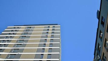 Modern luxury residential flat. Modern apartment building on a sunny day. Apartment building with a blue sky. Facade of a modern apartment building. photo