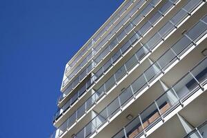 Exterior of a modern multi-story apartment building - facade, windows and balconies. photo