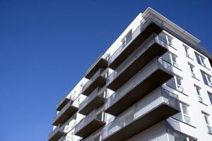 Exterior of a modern multi-story apartment building - facade, windows and balconies. photo