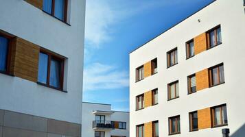 Modern apartment buildings on a sunny day with a blue sky. Facade of a modern apartment building. Glass surface with sunlight. photo