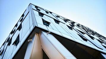 Combination of metal and glass wall material. Steel facade on columns. Abstract modern architecture. High-tech minimalist office building. Contemporary business architecture abstract fragment. photo
