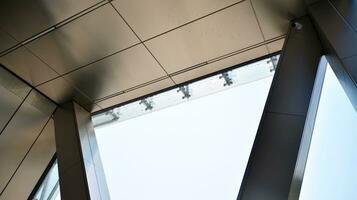 Combination of metal and glass wall material. Steel facade on columns. Abstract modern architecture. High-tech minimalist office building. Contemporary business architecture abstract fragment. photo