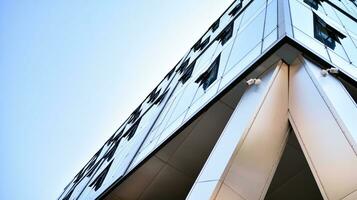 Combination of metal and glass wall material. Steel facade on columns. Abstract modern architecture. High-tech minimalist office building. Contemporary business architecture abstract fragment. photo