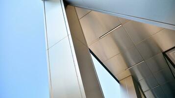 Combination of metal and glass wall material. Steel facade on columns. Abstract modern architecture. High-tech minimalist office building. Contemporary business architecture abstract fragment. photo