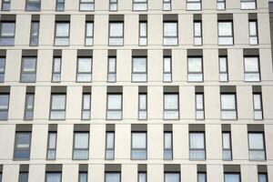 Exterior of a modern multi-story apartment building - facade, windows and balconies. photo