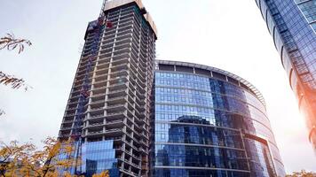 View of a skyscraper under construction. Modern architecture background. Building a high-rise building,  the concept of real estate construction. photo