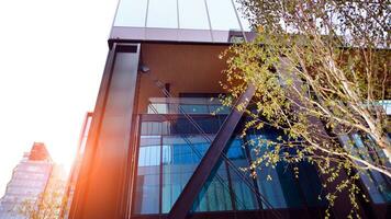 Combination of metal and glass wall material. Steel facade on columns. Abstract modern architecture. High-tech minimalist office building. Contemporary business architecture abstract fragment. photo