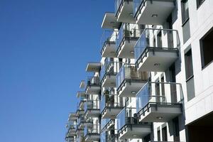Exterior of a modern multi-story apartment building - facade, windows and balconies. photo