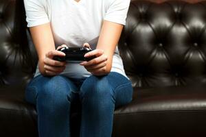 Closeup shot of manicured female hands with black gamepad photo