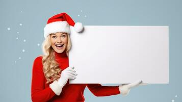 contento mujer vistiendo un de santa sombrero para Navidad participación un blanco firmar en un azul antecedentes con espacio para Copiar. ai generativo foto