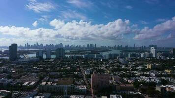 Urban Skyline of Miami Beach and Miami Downtown on Sunny Day. Blue Sky and Clouds. Aerial View. USA. Drone Flies Sideways video