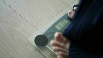 woman's feet on weight scale close up. video