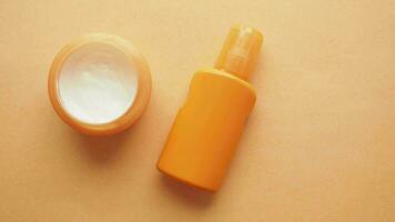 top view of sunscreen cream on orange color background video
