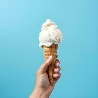 Female hand holding vanilla ice cream in waffle cone on blue background. High quality photo for design an advertising, banner, website. AI Generative