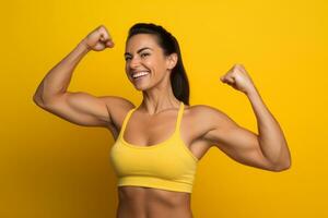 Excited female bodybuilder, fists up on yellow background. Generative AI photo