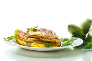 Fried omelette with zucchini,in a plate on a white background. photo