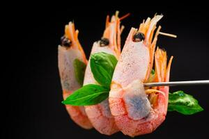 boiled shrimp with spices on black background photo