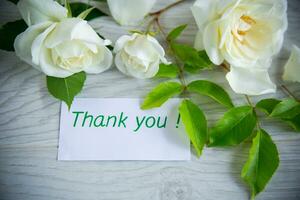 beautiful white summer roses, on a wooden table photo