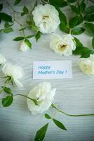 background of many white roses on a light wooden photo