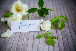 beautiful white summer roses, on a wooden table photo
