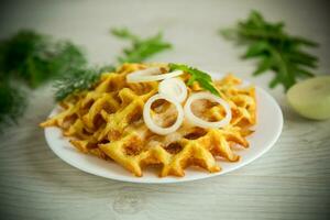 fried potato cheese vegetable waffles with bacon and onions photo