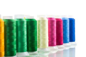 set of different color sewing threads,on white background. photo