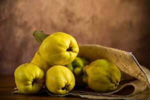 Ripe natural autumn quince on wooden table. photo