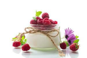 Sweet cooked homemade yogurt with fresh raspberries in a glass jar. photo