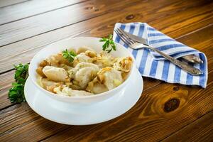 Ukrainian Vareniky or Pierogi stuffed with potato and mushrooms, served with fried onion. photo