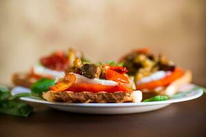 Prepared sandwich with tomatoes, mozzarella and fried eggplant with mushrooms. photo