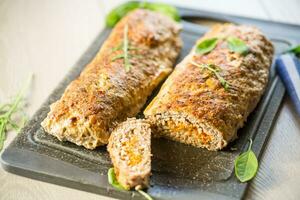 Cooked minced meatloaf with vegetable filling inside. photo