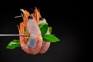 boiled shrimp with spices on black background photo