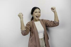 A young Asian woman employee with a happy successful expression wearing cardigan isolated by white background photo