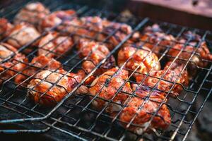 golden brown grilled chicken meat is cooked on the grill outdoors photo