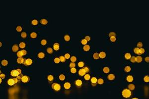 background, texture. Yellow round bokeh stars on black background photo