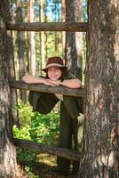 Cute girl in suit and hat in nature photo