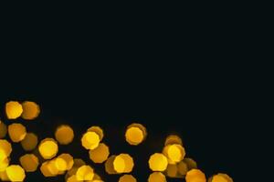 background, texture. Yellow round bokeh stars on black background photo