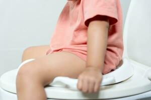 child going to the toilet, constipation in children, dyspepsia, abdominal pain, crying, defecating, straining, urinary incontinence, blood in the stool, bowel problems, ulcerative colitis, diarrhea photo