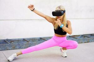 Sportswoman in VR headset practicing kung fu photo