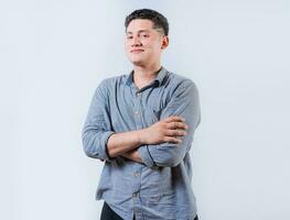 Portrait of smiling latin man with arms crossed isolated. Young casual latin man smiling at camera. Smiling young nicaraguan man isolated photo