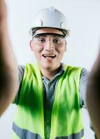 Cheerful builder engineer taking a selfie isolated. Engineer taking a selfie isolated. Smiling male engineer taking a selfie looking at camera photo